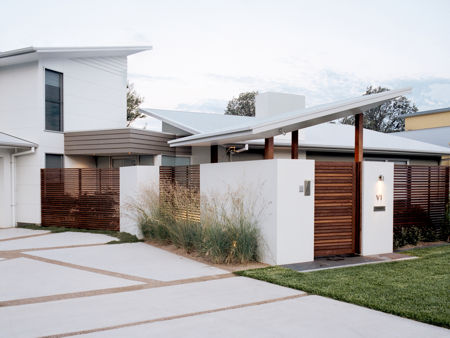 Contemporary residence with Exfoliated Buffalo granite pavers as front pathway (below gate)