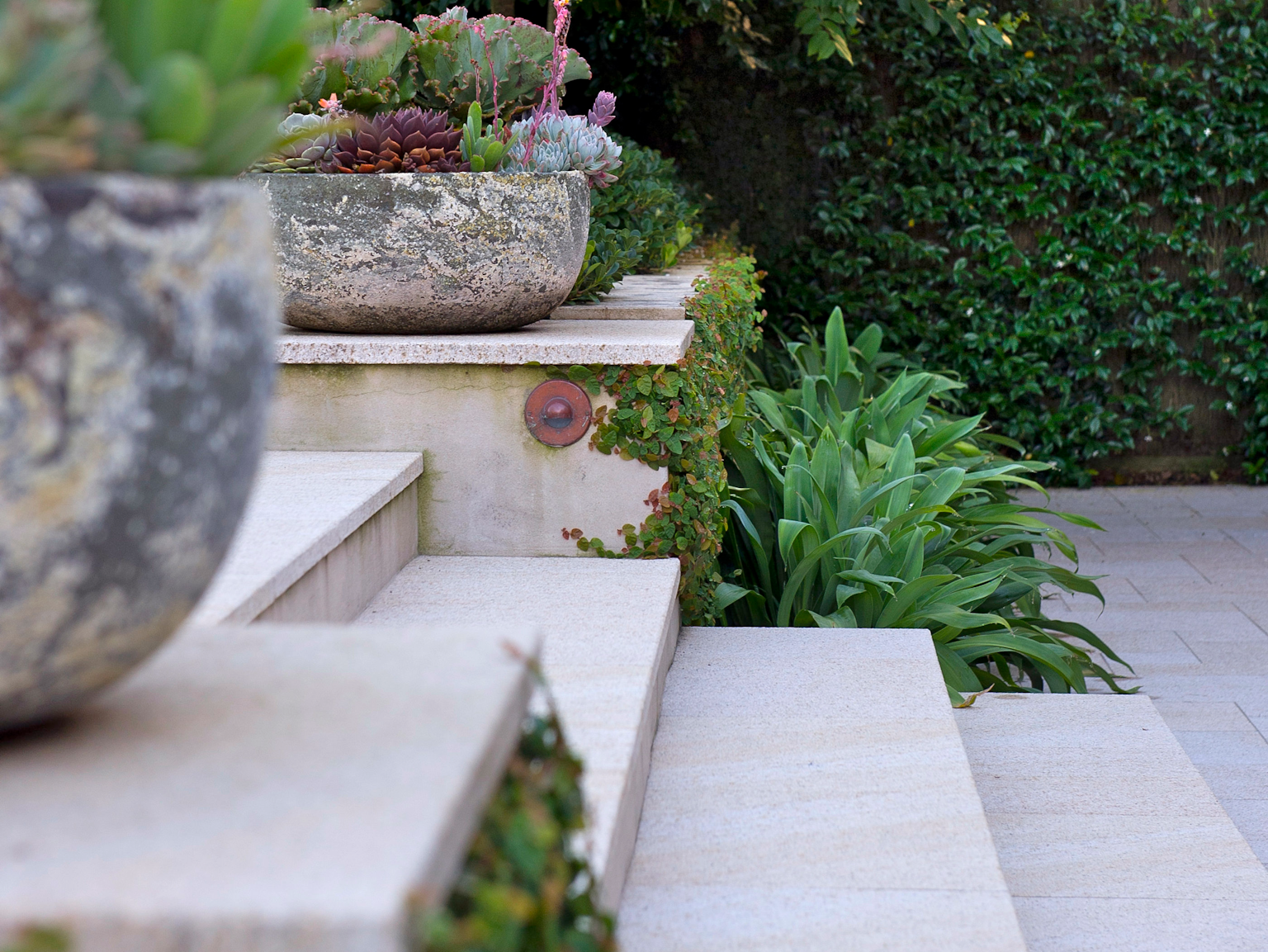 Stairs in Tortoise granite paving with retaining walls also capped in Tortoise granite