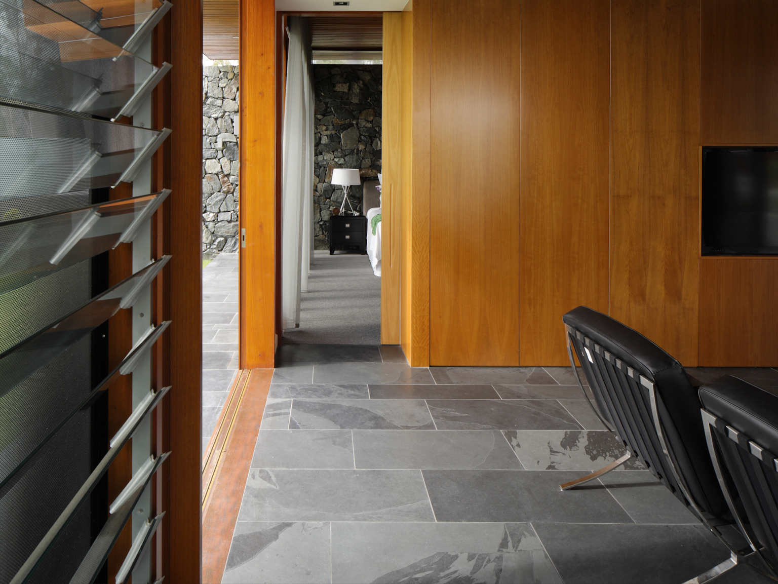 Large format Abyss split stone pavers used as internal flooring with wooden features
