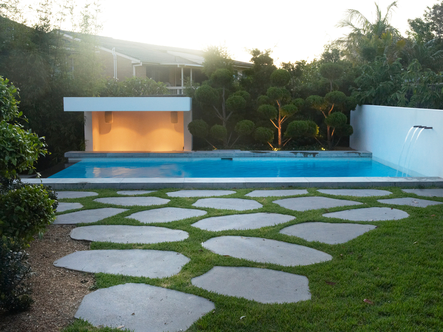 Garden design with bluestone organic steppers and rebated coping units around pool