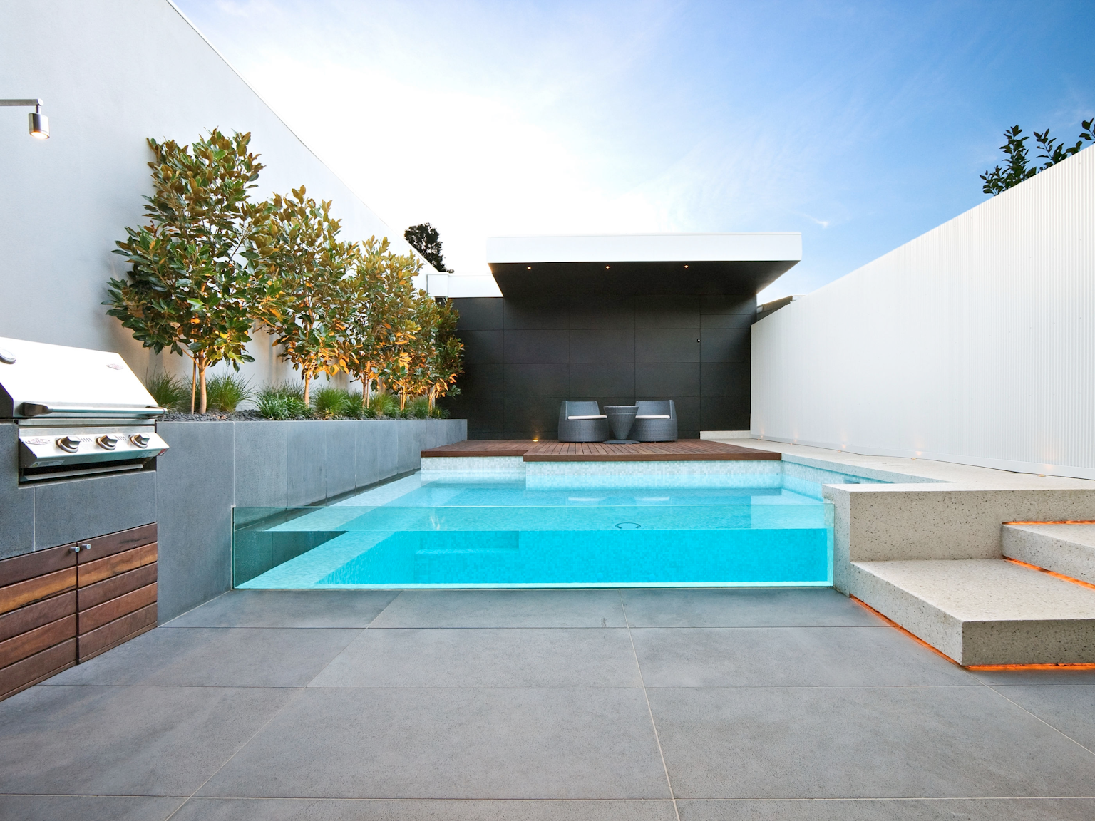 Large bluestone pavers used as pool wall and BBQ area