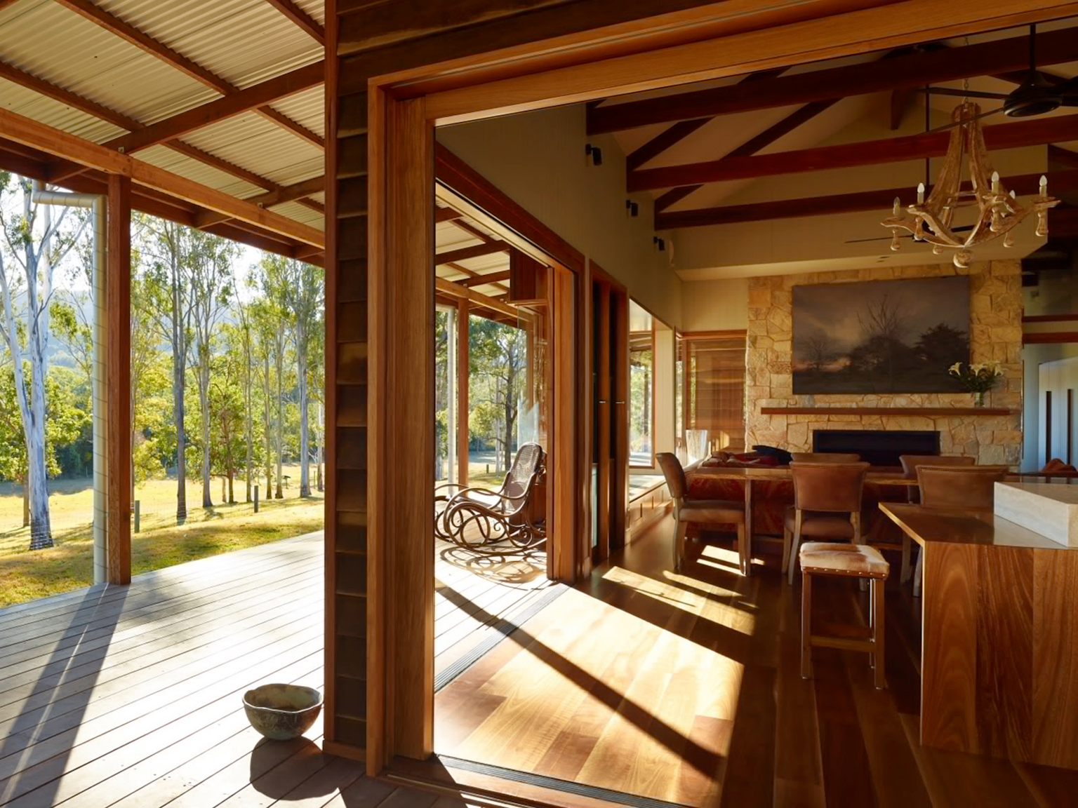 Open plan living space to veranda with fireplace clad with Coolum random ashlar limestone walling 