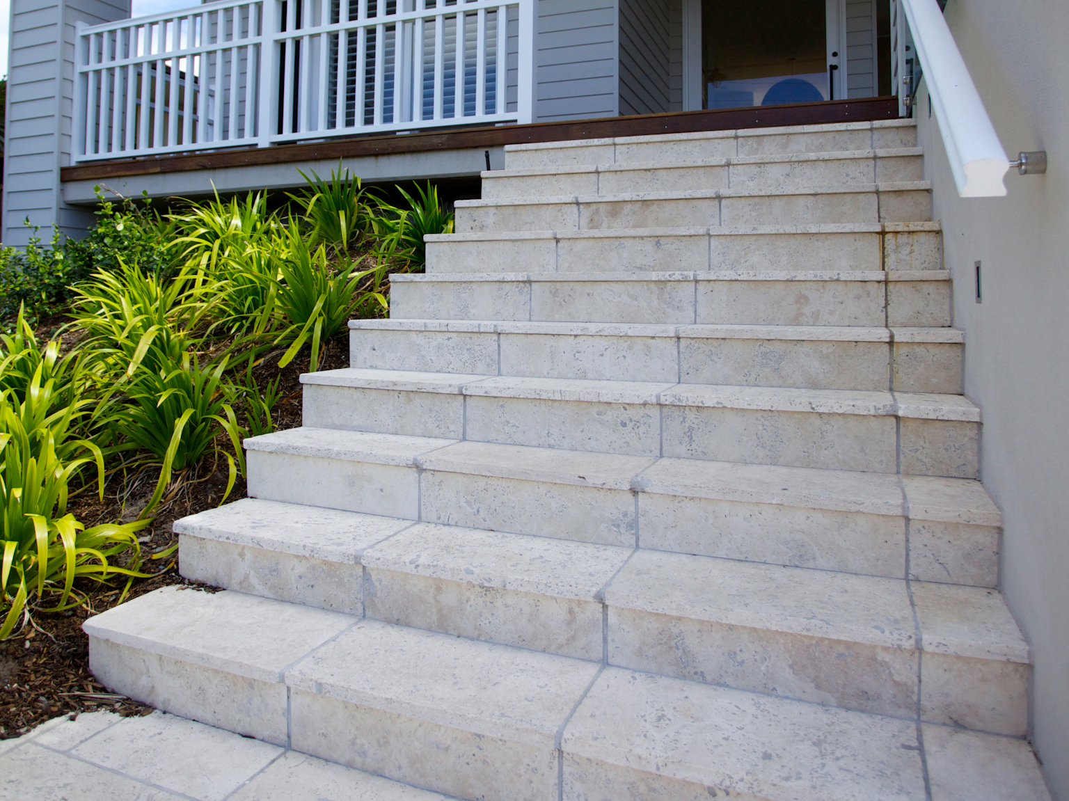 Front entrance staircase using Ravello travertine modular paving and tumbled step treads