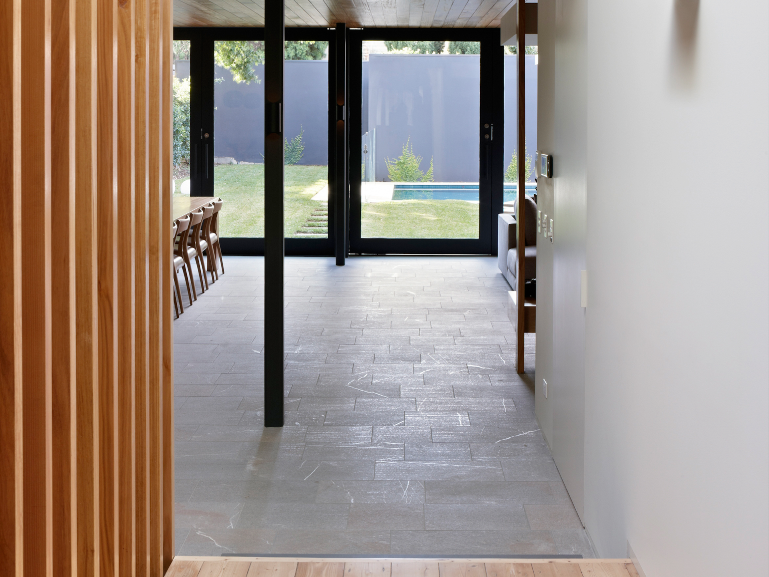 View from internal corridor towards garden showing Lagano granite paving in the living room