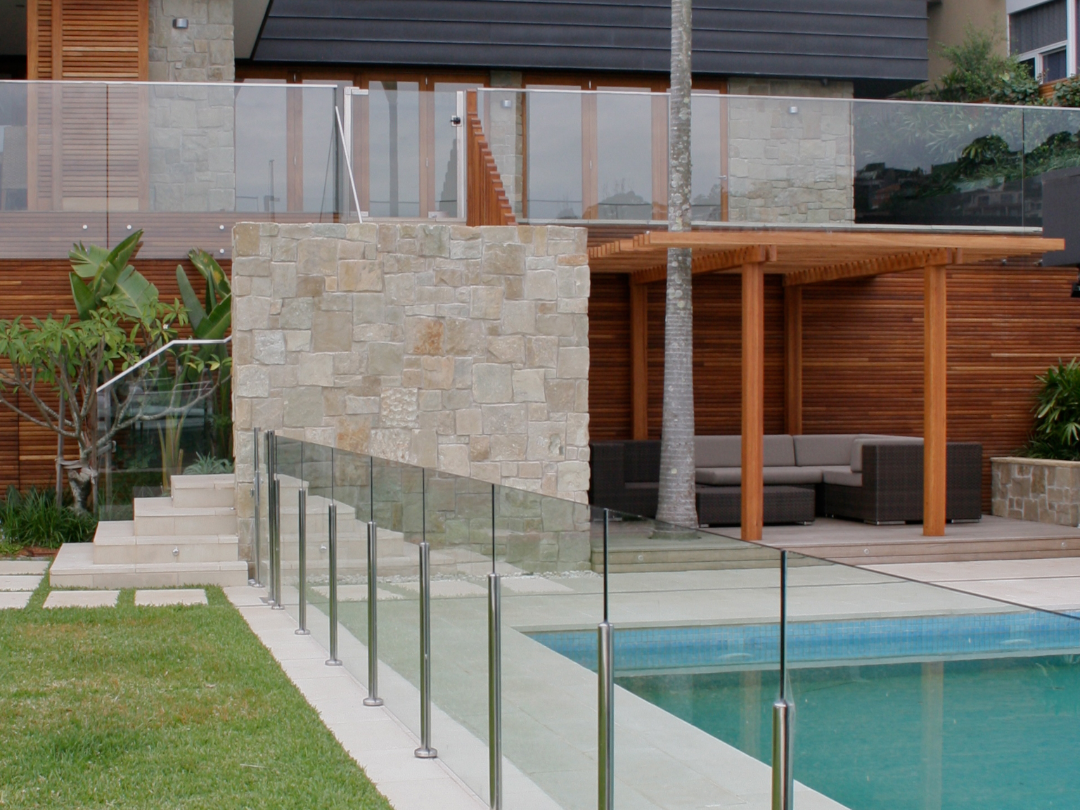 Pool area using Cashmere concrete pavers and coping units with Clancy random ashlar sandstone walling in background