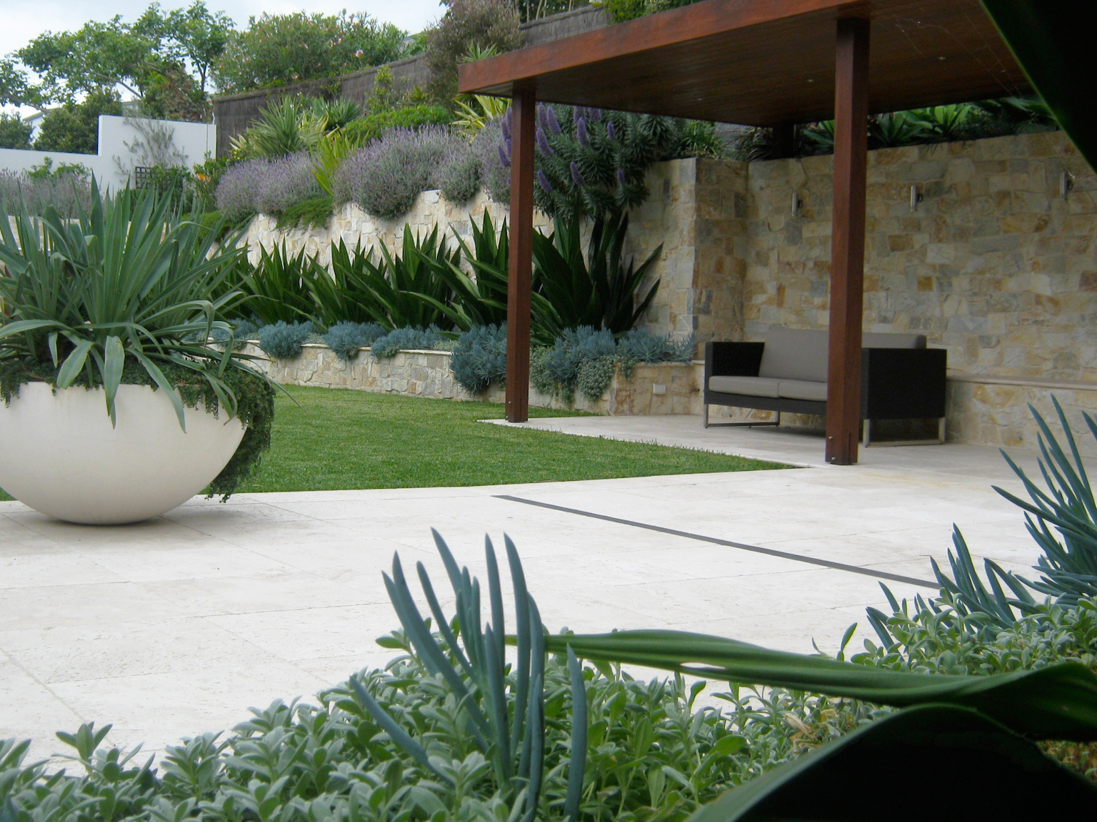 View of enclosed garden with Coolum random ashlar limestone walling on boundary walls