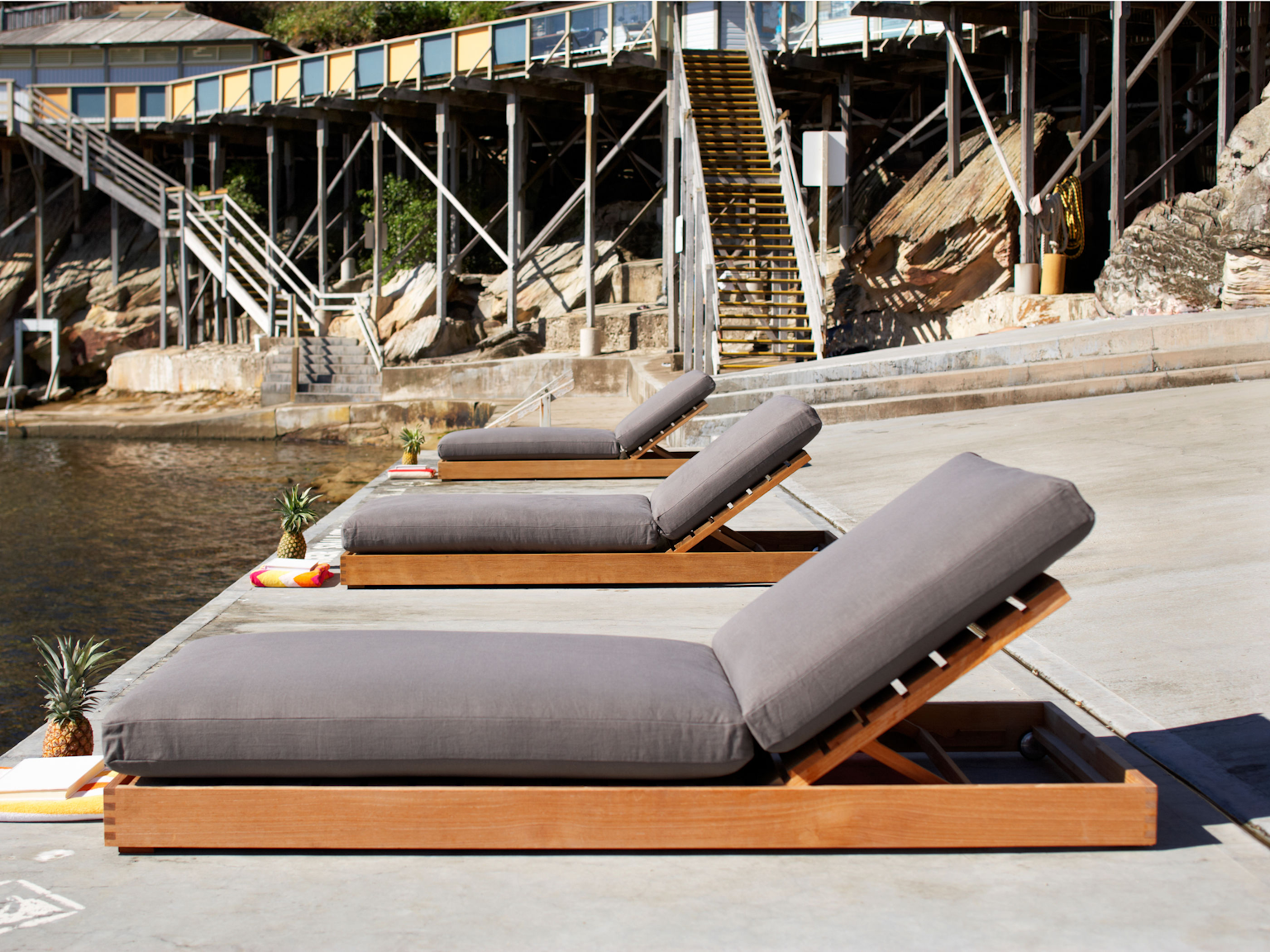 Burleigh daybeds with cushions in Outdoor Linen Shale at sea pool 
