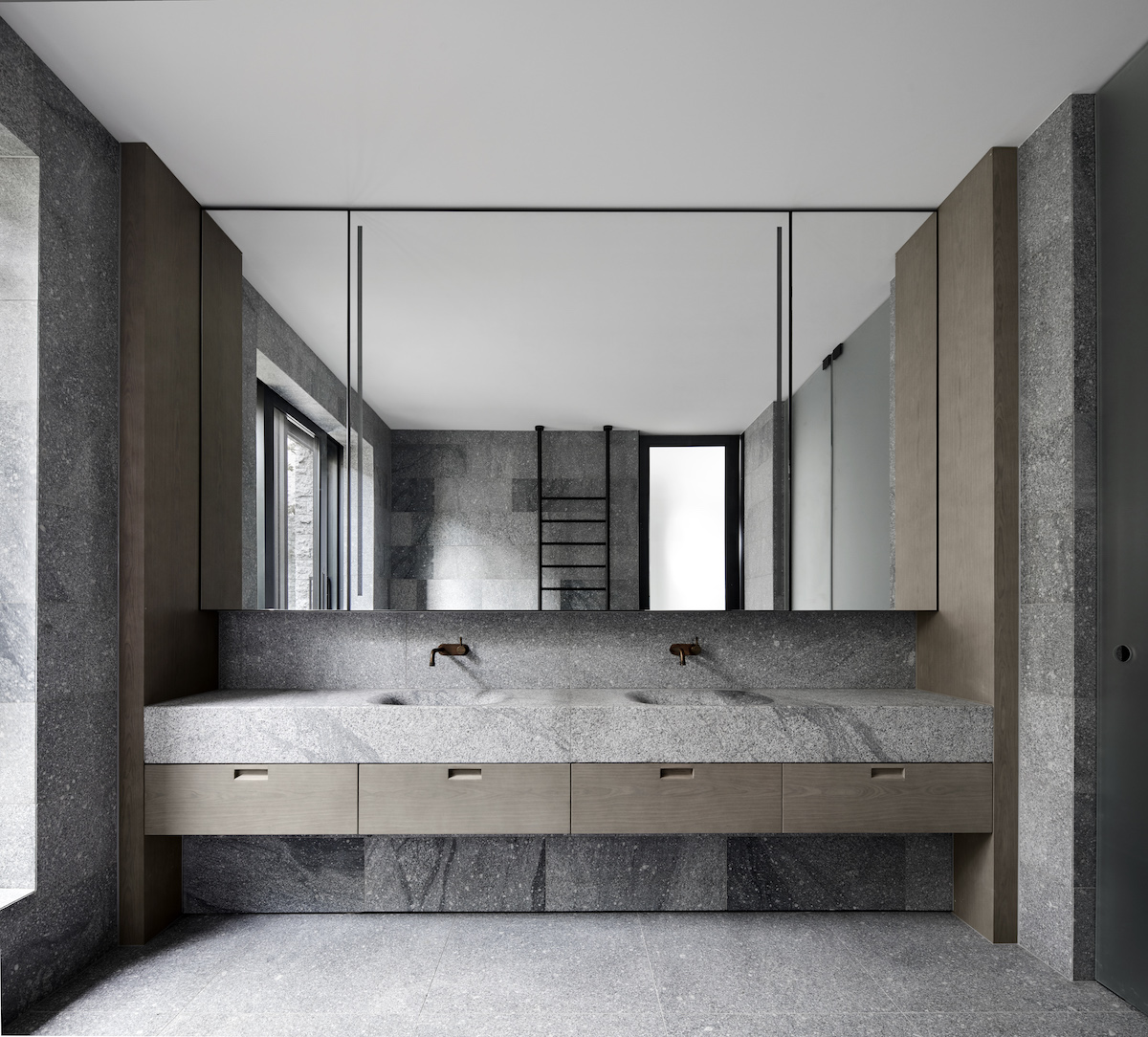 Bathroom by B.E architecture featuring Eco Outdoor Fallow Granite and limed walnut joinery