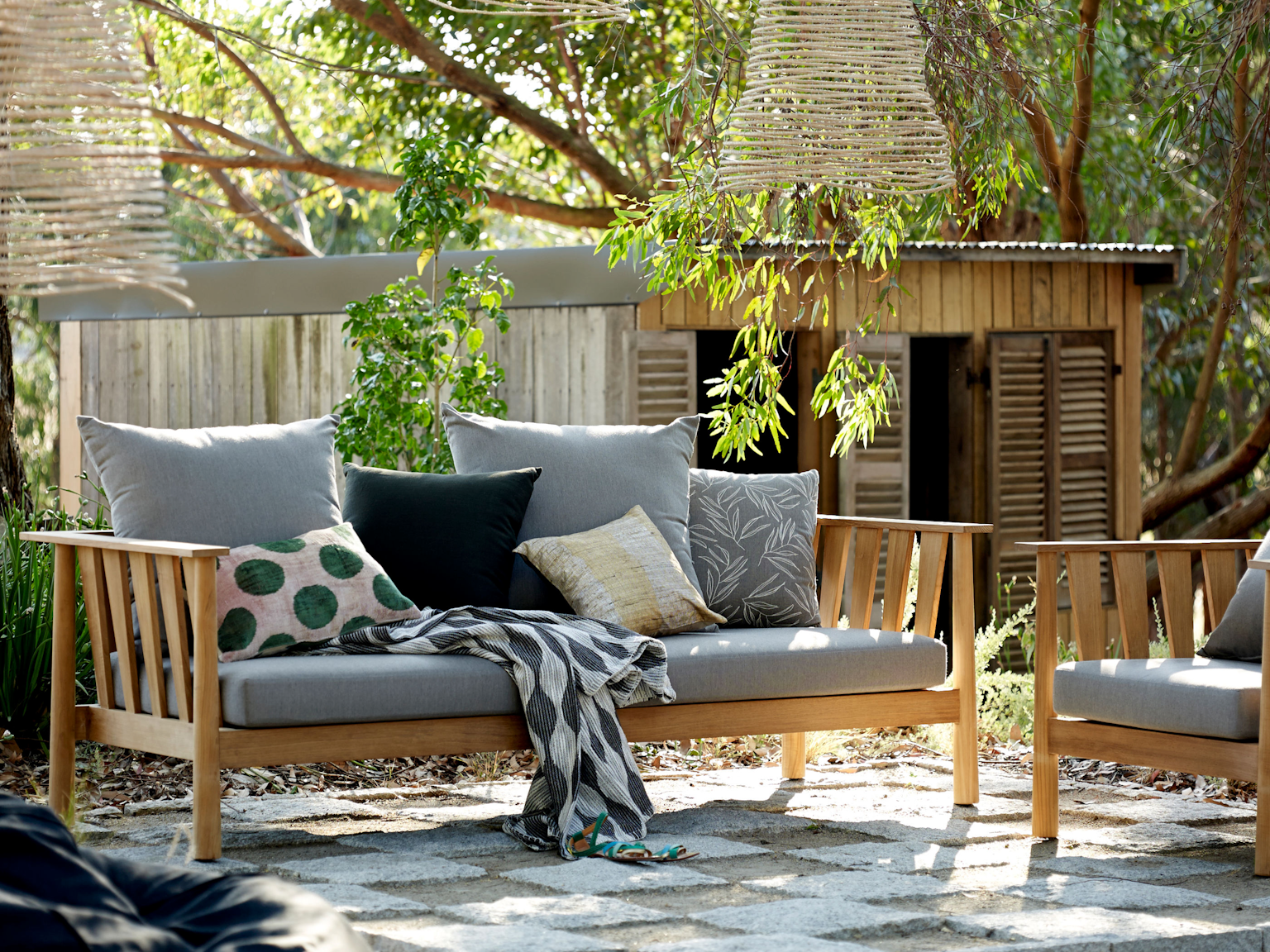 Malua 3.5 seat lounge and Malua lounge chair in outdoor fabric Basics in garden setting 