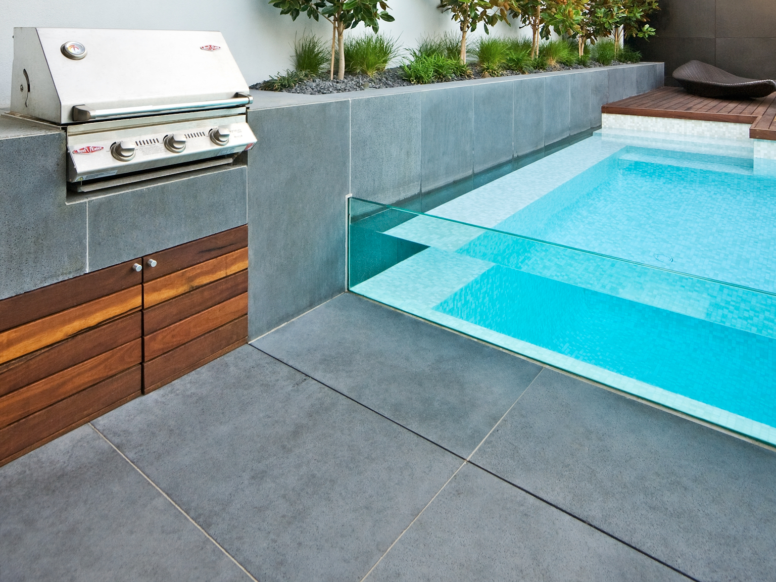 View of large format bluestone pavers used as flooring and walling in pool area