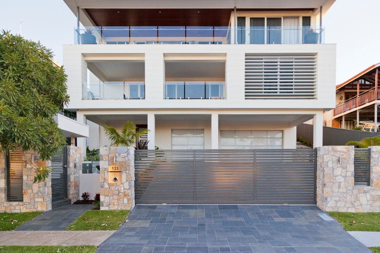 Bluestone modular paving and Coolum natural stone walling  soften the architecture